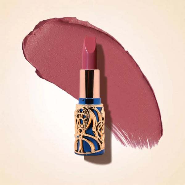 Swiss Miss Bling Lipstick in shade Cashmere Cocoa B-105 featuring ornate blue and gold filigree bullet tube casing with a rich mauve cocoa brown lipstick swatch.