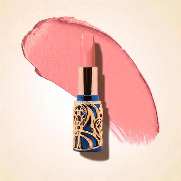 Swiss Miss Bling Lipstick in shade Romantic Pink B-106 featuring ornate blue and gold filigree bullet tube casing with a soft light romantic pink lipstick swatch.