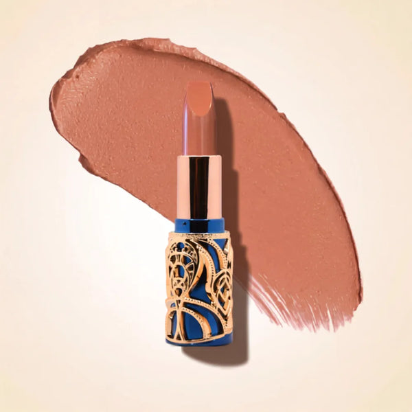 Swiss Miss Bling Lipstick in shade Soft Brown B-101 featuring ornate blue and gold filigree bullet tube casing with a soft nude brown lipstick swatch.