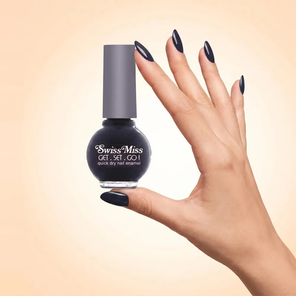 Swiss Miss Get Set Go Quick Dry Nail Enamel in shade Black 294 held by hand showing round glass bottle with rich glossy deep jet black polish and matching manicured nails.