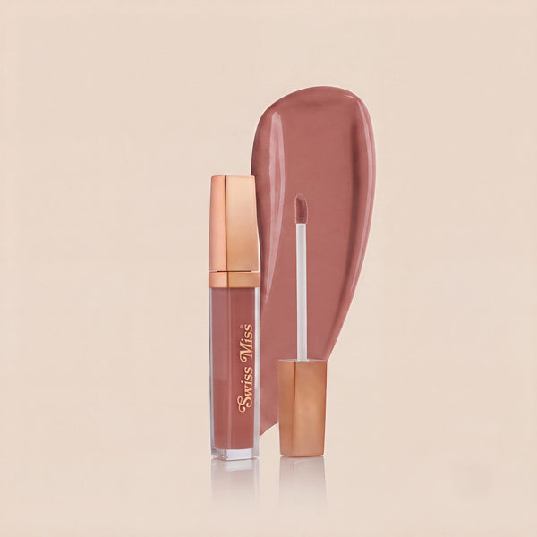 Swiss Miss High Shine Lip Gloss in shade 101 Rosy Glow featuring rose gold cap, applicator wand, and dusty rose lip gloss swatch.