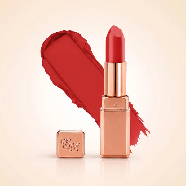 Swiss Miss Silk Matte Lipstick in shade Coral Pink 726 featuring sleek rose gold metallic square tube casing with a vibrant warm red coral pink lipstick swatch.