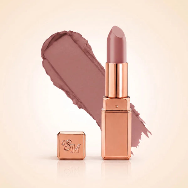 Swiss Miss Silk Matte Lipstick in shade So Plum 720 featuring sleek rose gold metallic square tube casing with a muted soft plum mauve nude lipstick swatch.