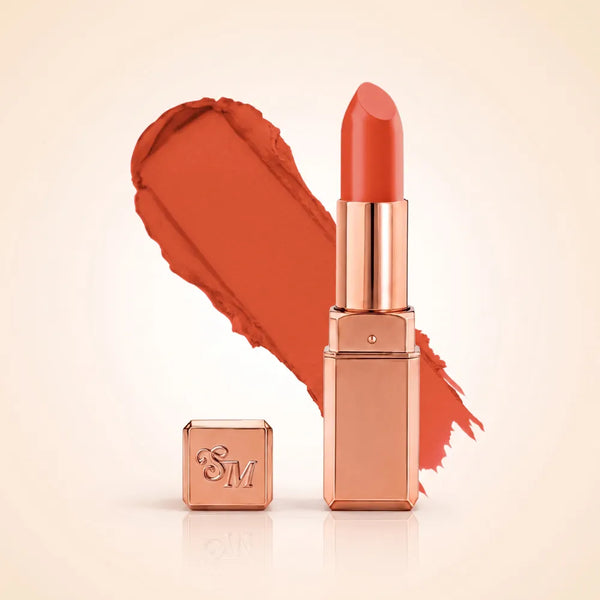 Swiss Miss Silk Matte Lipstick in shade Tangerine 728 featuring sleek rose gold metallic square tube casing with a warm bright orange tangerine lipstick swatch.