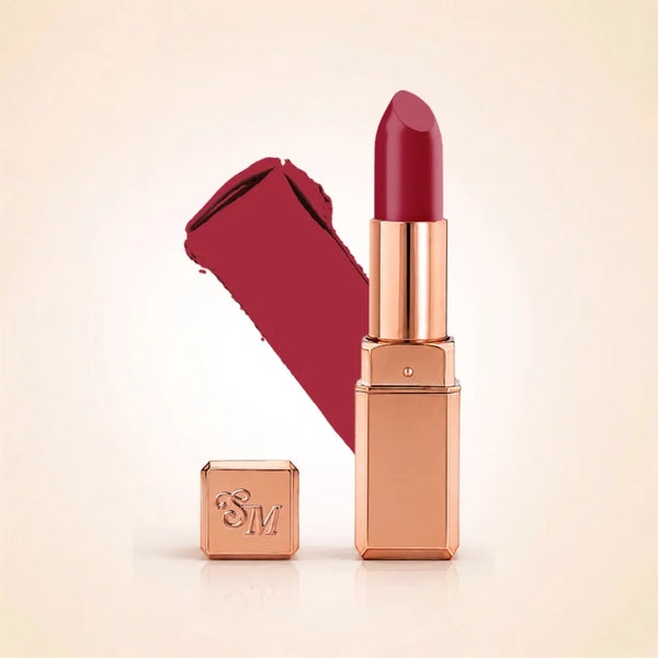 Swiss Miss Silk Lipstick in shade Ruby Pink (717) in gold bullet packaging shown alongside a textured cream color swatch.