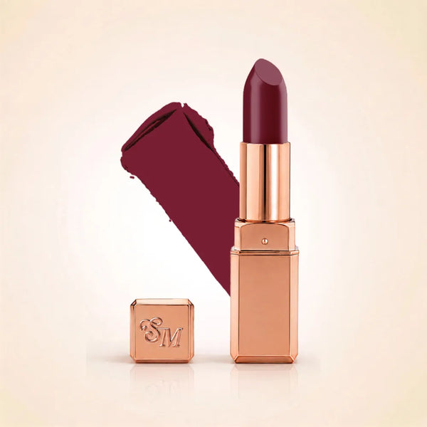 Swiss Miss Silk Lipstick in shade Viva Heart (725) in gold bullet packaging shown alongside a textured cream color swatch.