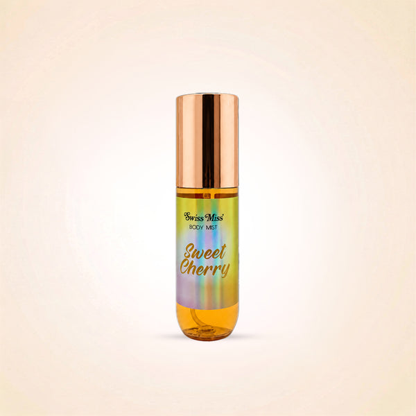 A roll-on body mist bottle with a metallic rose gold cap and a label that reads 'Swiss Mist BODY MIST' and 'Sweet Cherry' in gold script, set against a light beige background.