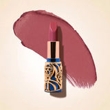 Swiss Miss Bling Lipstick in shade Cashmere Cocoa B-105 featuring ornate blue and gold filigree bullet tube casing with a rich mauve cocoa brown lipstick swatch.