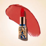 Swiss Miss Bling Lipstick in shade Red Diva B-116 featuring ornate blue and gold filigree bullet tube casing with a vibrant warm scarlet red lipstick swatch.