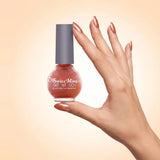 Swiss Miss Get Set Go Quick Dry Nail Enamel in shade Autumn Blaze F-408 held by hand showing round glass bottle with shimmering metallic warm burnt orange copper polish and matching manicured nails.