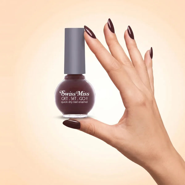 Swiss Miss Get Set Go Quick Dry Nail Enamel in shade Dark Chocolate 223 held by hand showing round glass bottle with deep dark chocolate brown polish and matching manicured nails.