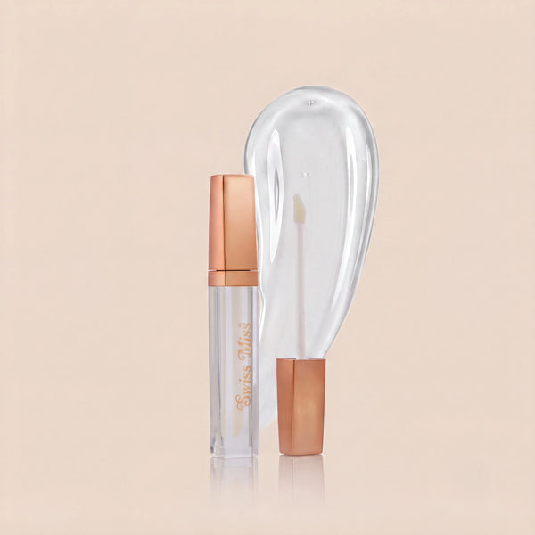 Swiss Miss High Shine Lip Gloss in clear shade 100 Glass Glow featuring rose gold cap, applicator wand, and glossy transparent swatch.