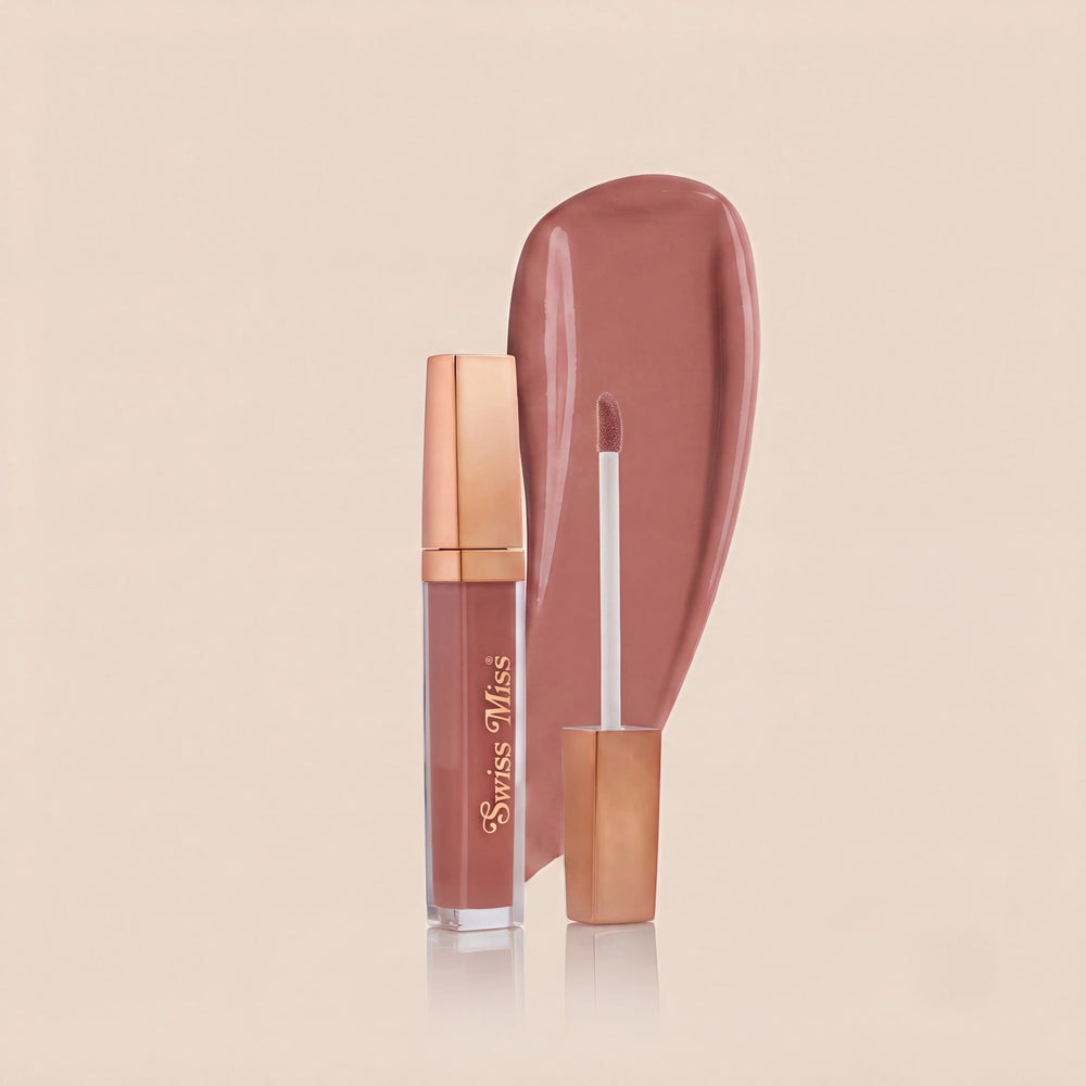 Swiss Miss High Shine Lip Gloss in shade 101 Rosy Glow featuring rose gold cap, applicator wand, and dusty rose lip gloss swatch.