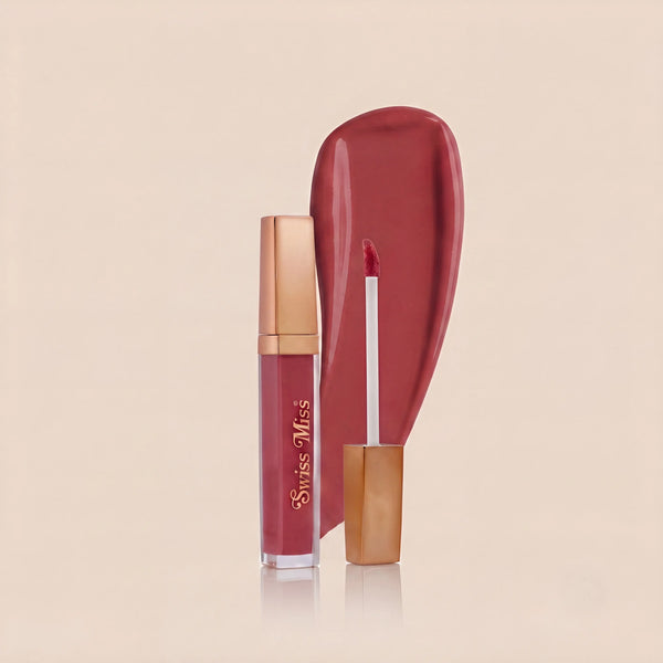 Swiss Miss High Shine Lip Gloss in shade 104 Rose Allure featuring rose gold cap, applicator wand, and deep rose caramel lip gloss swatch.