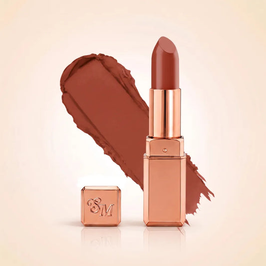 Swiss Miss Silk Matte Lipstick in shade Birkin Brown 707 featuring sleek rose gold metallic square tube casing with a deep reddish cocoa brown lipstick swatch.