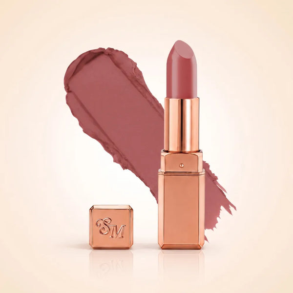 Swiss Miss Silk Matte Lipstick in shade Almond Ice 705 featuring sleek rose gold metallic square tube casing with a cool mauve pink almond nude lipstick swatch.