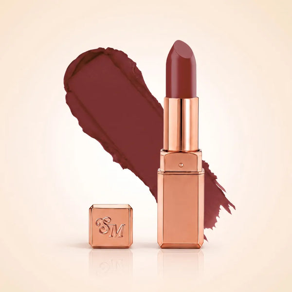Swiss Miss Silk Matte Lipstick in shade Belgian Spice 708 featuring sleek rose gold metallic square tube casing with a deep berry wine plum lipstick swatch.