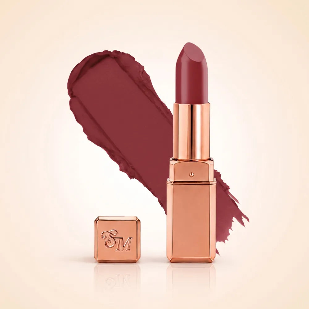 Swiss Miss Silk Matte Lipstick in shade Candy Crush 716 featuring sleek rose gold metallic square tube casing with a rich deep plum berry wine lipstick swatch.