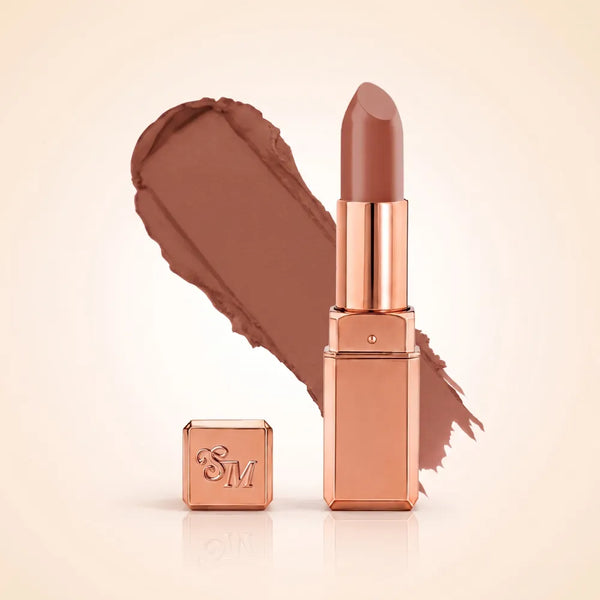 Swiss Miss Silk Matte Lipstick in shade Caramel Nude 703 featuring sleek rose gold metallic square tube casing with a warm beige caramel brown nude lipstick swatch.