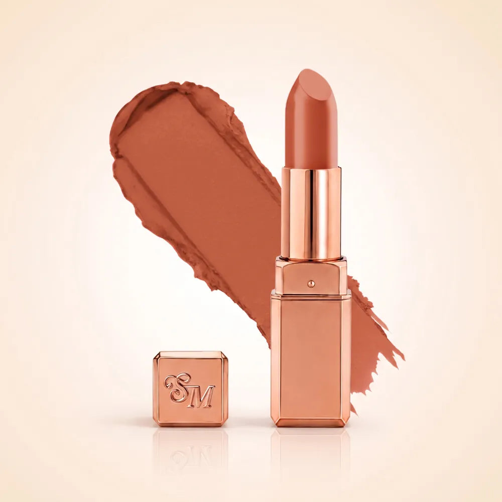 Swiss Miss Silk Matte Lipstick in shade Glitter Bomb 729 featuring sleek rose gold metallic square tube casing with a warm peach nude terracotta lipstick swatch.