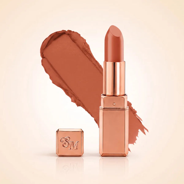 Swiss Miss Silk Matte Lipstick in shade Glitter Bomb 729 featuring sleek rose gold metallic square tube casing with a warm peach nude terracotta lipstick swatch.