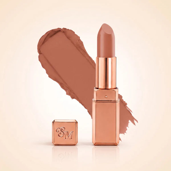Swiss Miss Silk Matte Lipstick in shade Pillow Kiss 732 featuring sleek rose gold metallic square tube casing with a warm soft peachy beige nude lipstick swatch.