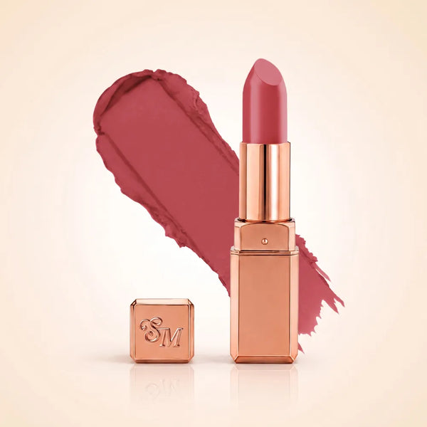 Swiss Miss Silk Matte Lipstick in shade Rose Dream 715 featuring sleek rose gold metallic square tube casing with a vibrant deep rose mauve pink lipstick swatch.