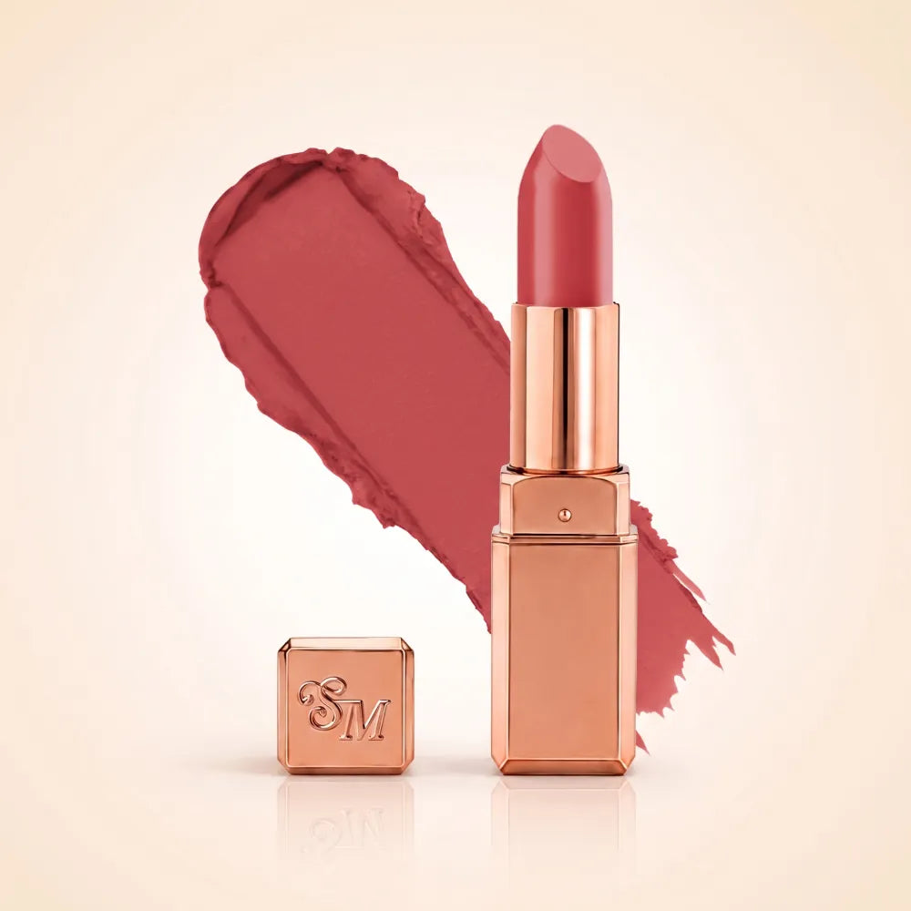 Swiss Miss Silk Matte Lipstick in shade Rouge Pink 714 featuring sleek rose gold metallic square tube casing with a warm rosewood pink lipstick swatch.