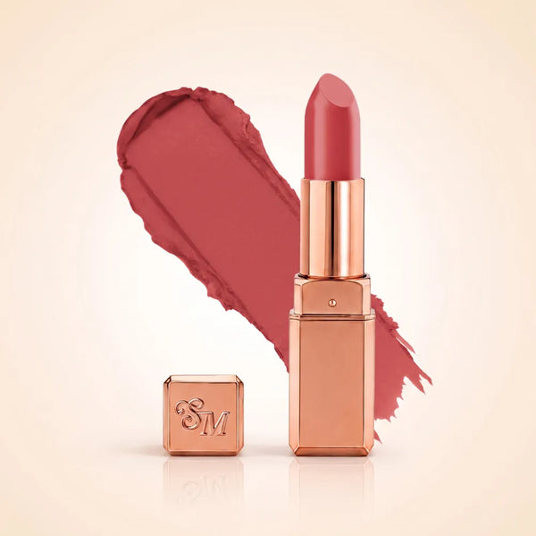 Swiss Miss Silk Matte Lipstick in shade Rouge Pink 714 featuring sleek rose gold metallic square tube casing with a warm rosewood pink lipstick swatch.