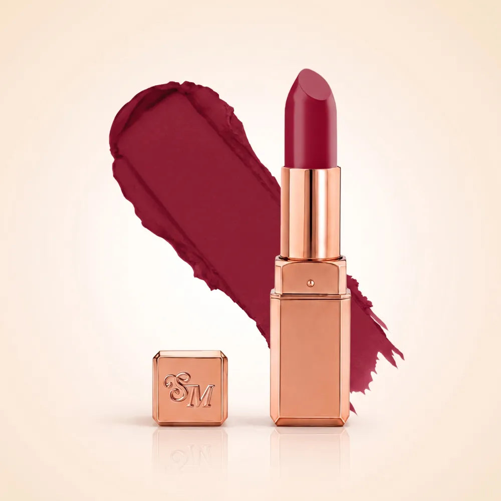 Swiss Miss Silk Matte Lipstick in shade Ruby Pink 717 featuring sleek rose gold metallic square tube casing with a vibrant deep ruby magenta pink lipstick swatch.