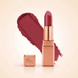 Swiss Miss Silk Matte Lipstick in shade Velvet Blush 712 featuring sleek rose gold metallic square tube casing with a rich deep mauve plum berry lipstick swatch.