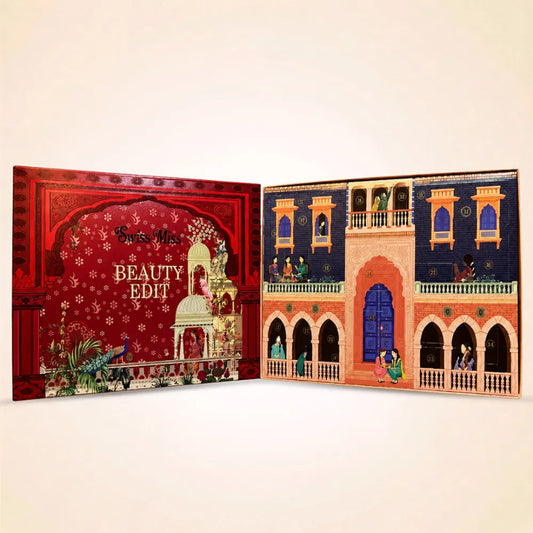 Open Swiss Miss Beauty Edit advent calendar showing numbered doors styled like a traditional archway building.