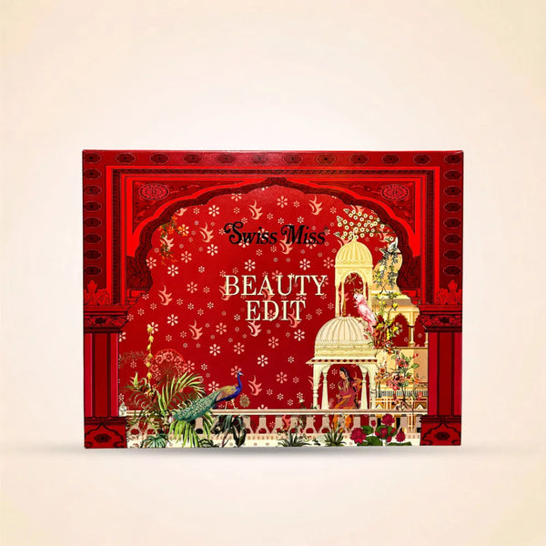 Front view of the Swiss Miss Beauty Edit red gift box packaging with traditional motif illustrations.