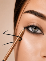 Close-up of model applying Swiss Miss Eye Pencil in 01 Black to the upper lash line with a drawn liner stroke overlay.