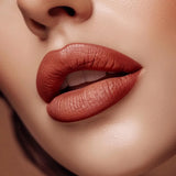 Close-up of lips wearing Swiss Miss Bronze Affair B-113 matte lipstick shade.