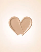 Heart-shaped liquid texture swatch of Swiss Miss Matte and Poreless CC Concealer in shade Peachy Pink SM 04
