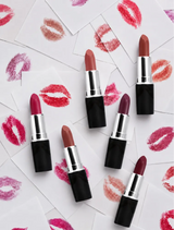 Multiple open Swiss Miss Classic Lipsticks displayed over cards with colorful lip prints.