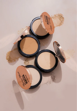 Four open Swiss Miss Flawless Match Compact Powder cases displayed together showing various skin tone shades over soft powder swatches.