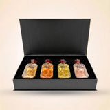 Front view of open black Swiss Miss perfume gift box showcasing a set of four mini fragrance bottles.