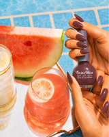 Woman holding Swiss Miss Get Set Go quick dry nail polish bottle in Rose Wood 245 with a deep earthy rose-brown manicure by a pool.