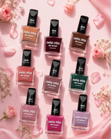 Flat lay display of Swiss Miss Silk Lacquer nail polish bottles in various shades surrounded by pink rose petals and flowers.