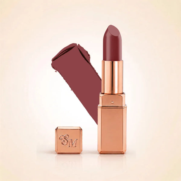 Swiss Miss Silk Lipstick in shade Belgian Spice (708) in gold bullet packaging shown alongside a textured cream color swatch.