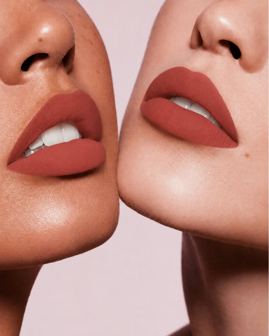 Close-up shot of two models with different skin tones wearing Swiss Miss Silk Lipstick in shade Birkin Brown (707).