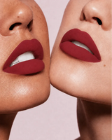 Close-up shot of two models with different skin tones wearing Swiss Miss Silk Lipstick in shade Cherry Brown (709).
