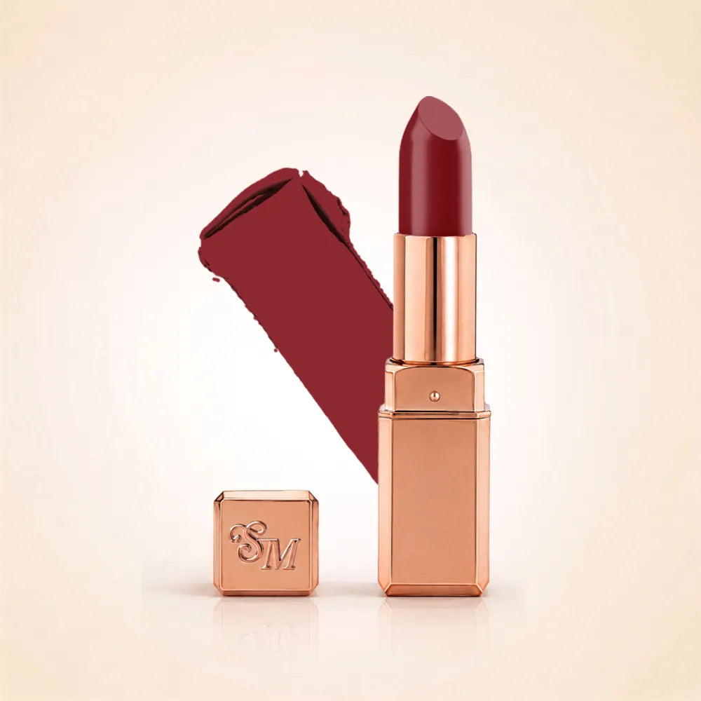 Swiss Miss Silk Lipstick in shade Cherry Brown (709) in gold bullet packaging shown alongside a textured cream color swatch.