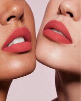 Close-up shot of two models with different skin tones wearing Swiss Miss Silk Lipstick in shade Coral Pink (726).