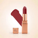 Swiss Miss Silk Lipstick in shade Deep Scarlet (718) in gold bullet packaging shown alongside a textured cream color swatch.