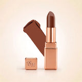 Swiss Miss Silk Lipstick in shade Espresso (730) in gold bullet packaging shown alongside a textured cream color swatch.