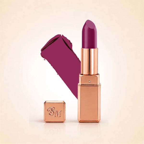 Swiss Miss Silk Lipstick in shade Mulberry (721) in gold bullet packaging shown alongside a textured cream color swatch.
