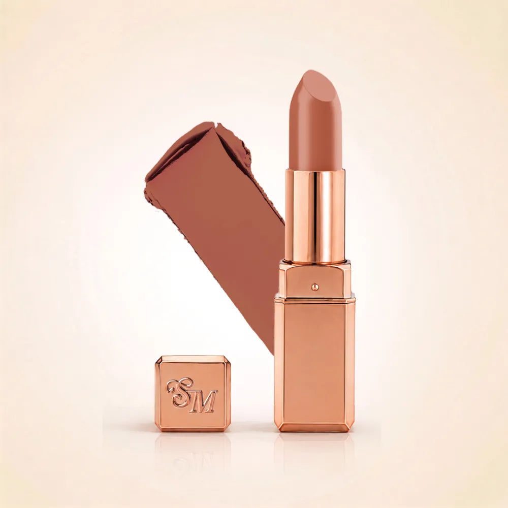 Swiss Miss Silk Lipstick in shade Pillow Kiss (732) in gold bullet packaging shown alongside a textured cream color swatch.